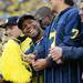 Former Michigan football player J.B. Fitzgerald smiles as he peeks over the railing during the third quarter against Michigan State at Michigan Stadium on Saturday afternoon. Melanie Maxwell I AnnArbor.com
